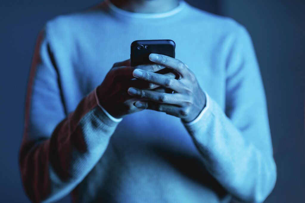 front-view-man-using-smartphone-scaled